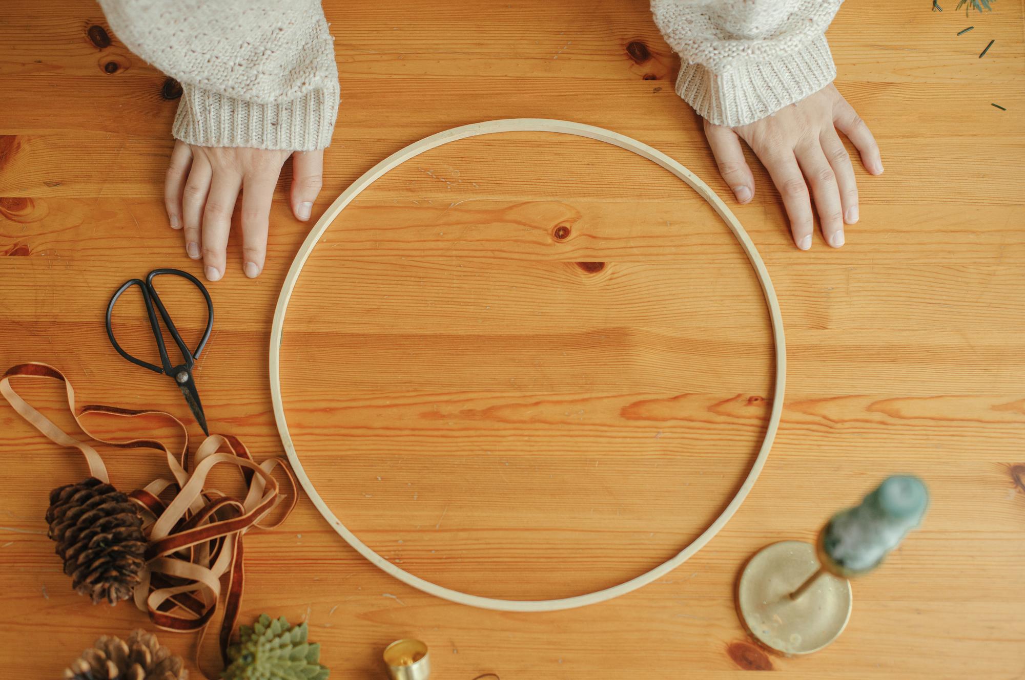hands preparing embroidery hoop on linen